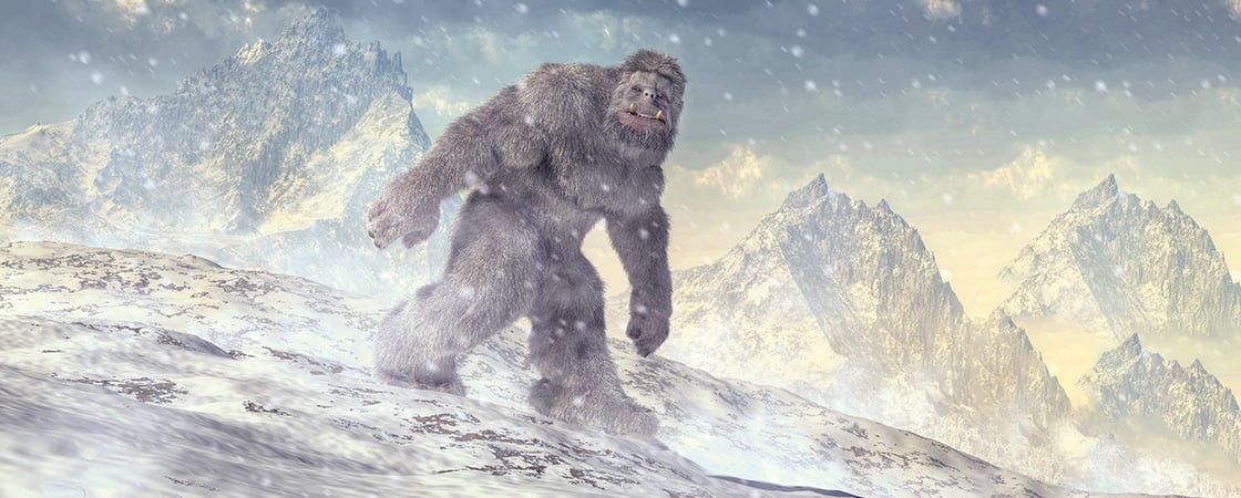 Image of a hairy Yeti traveling through snowy, mountain landscape